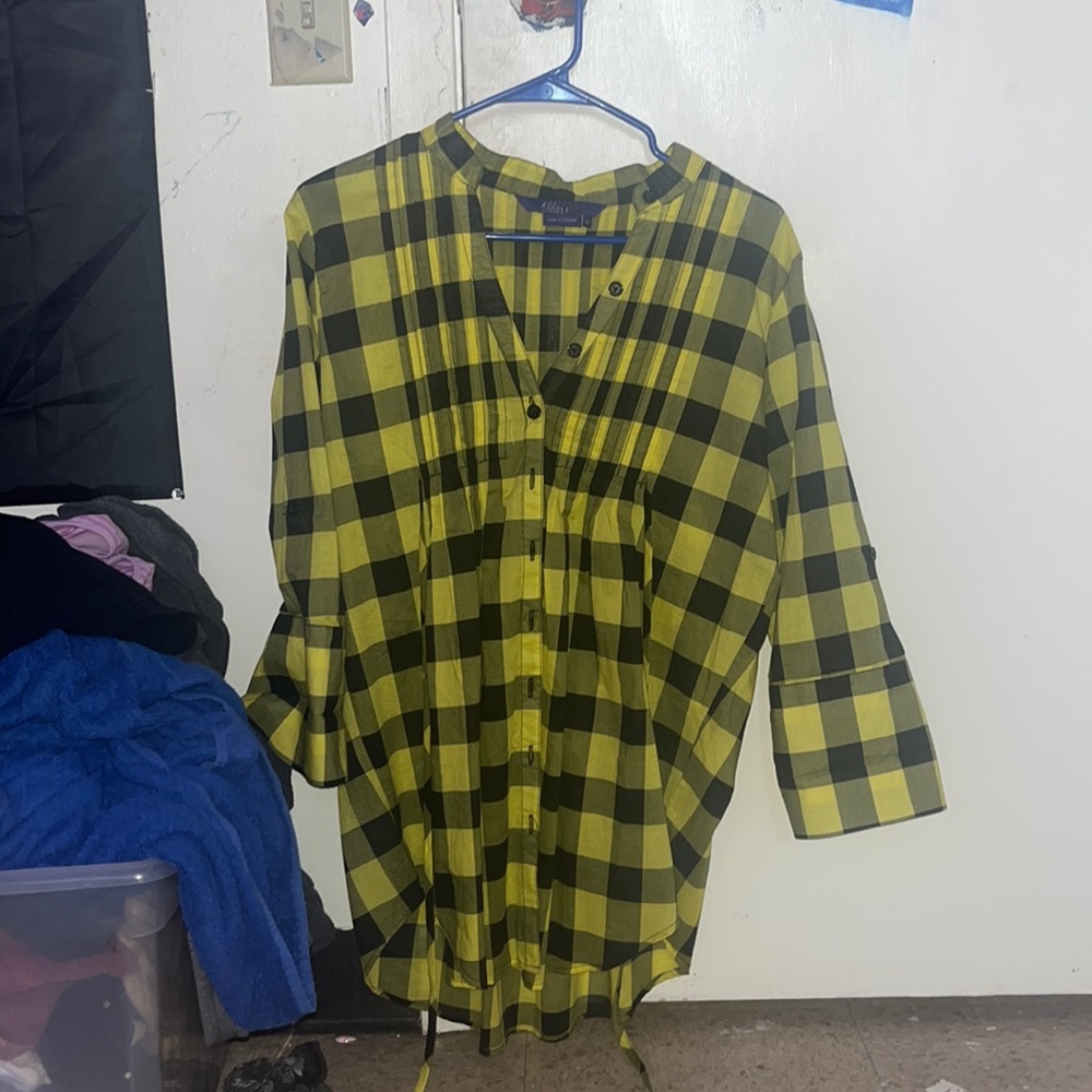 A yellow and black flannel. Brand: Miley Cyrus Max and it is a size XL